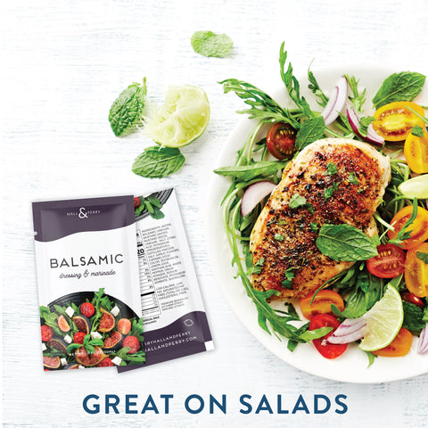 Single serve balsamic salad dressing packet next to chicken and tomato salad.